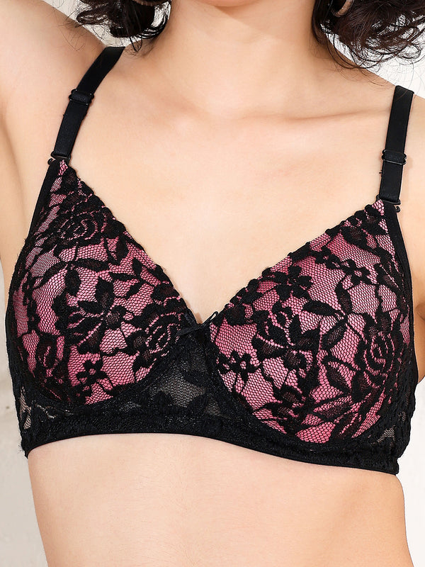 Black lace bra with pink floral patterns on a neutral background